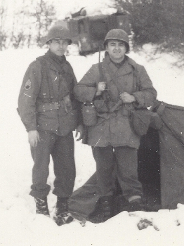 Members of the 26th Infantry Division campaigning in Luxembourg during December 1944.  The soldier on the left wears the M-1943 field jacket while his partner wears the late style mackinaw coat.