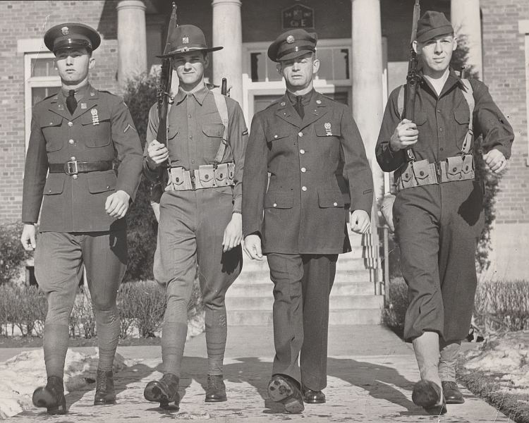 Old style Army enlisted uniforms, on the left, worn with breeches and new styles, on the right, worn with trousers.