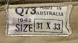 Label located on the inside waistband of the enlisted man's trousers shown to the left and right. The Q73 was a manufacturer's code with the Q indicating the location was in the state of Queensland and the 73 representing a specific contractor there. Label located on the inside waistband of the enlisted man's trousers shown to the left and right. The Q73 was a manufacturer's code with the Q indicating the location was in the state of Queensland and the 73 representing a specific contractor there.