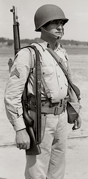 U.S. Army photograph taken at Ft. Benning, Georgia and published 13 August 1941 showing a non‐commissioned officer wearing the hot weather combat uniform. Note the shirt is worn with an open collar. When in the field, the necktie was not required. U.S. Army photograph taken at Ft. Benning, Georgia and published 13 August 1941 showing a non‐commissioned officer wearing the hot weather combat uniform. Note the shirt is worn with an open collar. When in the field, the necktie was not required.