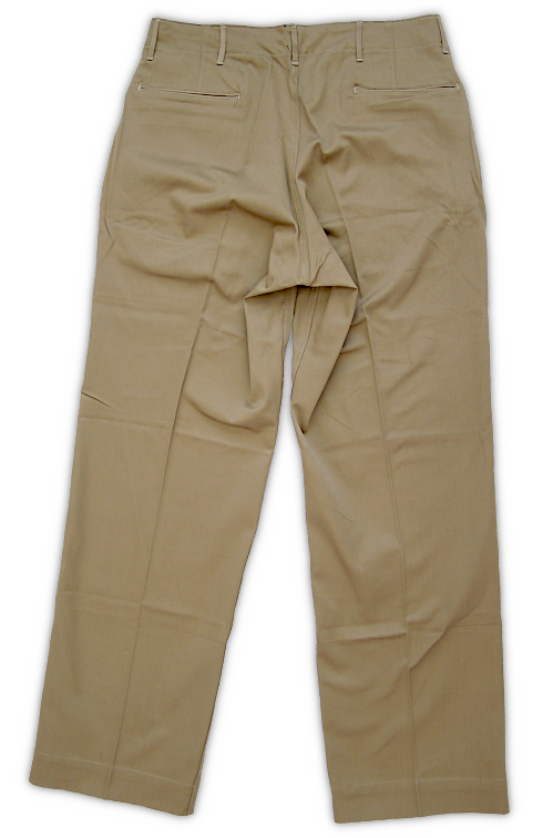 Rear view of the US Army khaki cotton trousers. Note the double welt pocket openings on the seat. This type of pocket construction would be simplified on later variants of khaki trousers. Shaping darts can be seen above each rear pocket. Khaki trousers were an essential part of the enlisted man's individual clothing allowance. During 1941‐42, most soldiers received two sets of khaki uniforms for their wardrobe. Khaki uniforms were not taken overseas unless traveling to a tropical climate. Rear view of the US Army khaki cotton trousers. Note the double welt pocket openings on the seat. This type of pocket construction would be simplified on later variants of khaki trousers. Shaping darts can be seen above each rear pocket. Khaki trousers were an essential part of the enlisted man's individual clothing allowance. During 1941‐42, most soldiers received two sets of khaki uniforms for their wardrobe. Khaki uniforms were not taken overseas unless traveling to a tropical climate.