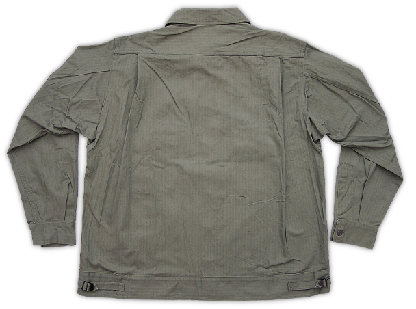 Back view of the herringbone twill jacket showing more of its intricate detail.  Note the shoulder yoke, shoulder pleats, and the adjustable buckles on the bottom band. Between the summer of 1941 and the summer of 1942, large quantities of these jackets were procured with only minor changes being made to the design during its production run. In the fall of 1942, a completely new design was introduced that helped facilitate mass production and was better suited for its newly assigned combat role.