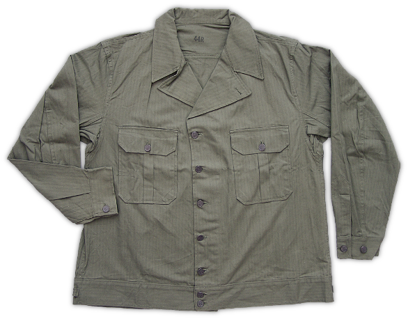 Front view of the herringbone twill jacket, Specification No. PQD 45, dated 3 April 1941.  This jacket, along with its matching trousers and hat, was designed to replace the denim chore uniform that had been in use since the end of WWI. The new herringbone twill uniform was considered an improvement over the denim type in that the material was longer wearing, the color was more appropriate for field use, and the styling was upgraded. Intricate in detail for a work uniform, the jacket was essentially modeled after western jean jackets of the time.   Note the shirt‐style cuffs, pleated front pockets, and banded waist.