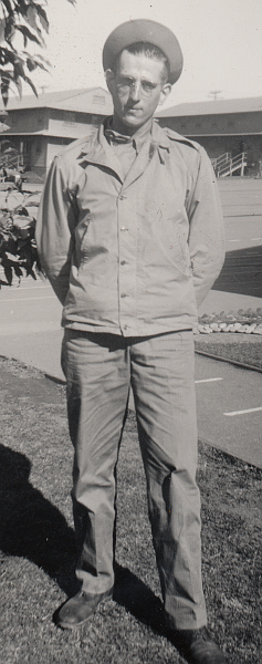 Here is another photo of Private John Sabon at training camp in 1942 wearing a newly issued two‐piece herringbone twill suit and hat with an olive‐drab field jacket worn as an outer garment.  The herringbone twill uniform proved to be a versatile outfit and could be used as conditions required.  It can be seen worn alone, over warmer clothing, and underneath jackets and coats.  Note the hat being worn on the back of the head with brim turned up.