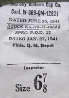 This is the contractor's label for the first model herringbone twill hat. Labels were located on the inside of the crown attached to the sweatband seam at the rear of the hat.  This particular label bears the manufacturer's name Mid City Uniform Cap Co., which was located in Chicago, IL.  The contract was issued for $184,000 and was completed in December 1941.