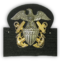Close-up of Navy officer's cap insignia.