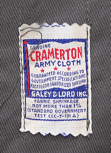 Close-up of manufacturers label found inside gray working coat.