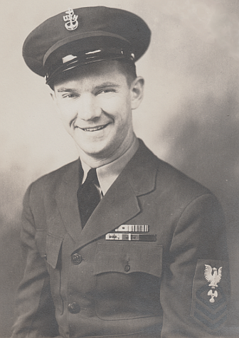 Chief Machinist's Mate wearing gray working uniform circa 1945. Approved colors for the rate badge were black for the eagle, specialty mark, and chevrons on a gray background. The white eagle and specialty mark were unauthorized.