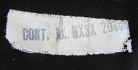 This photo shows the back side of the size/contractor label.  In this case a contract number is present indicating the jumper was made by an outside contractor and not the Naval Clothing Factory.  The stamp shows NXSX 20388 with the letter prefix belonging to the Bureau of Supplies and Accounts and the number falling in the range of those let in December, 1942.