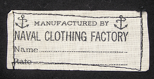 This cloth Naval Clothing Factory label is found on the nape of the jumper underneath the collar and contains lines for the sailor's name and rate.   Rate is the term the Navy uses to refer to an enlisted man's rank and job specialty.  Though these labels always say "Manufactured By Naval Clothing Factory", some WW2 blue jumpers and trousers were manufactured by outside contractors.
