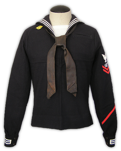 Front view of a US Navy dress blue jumper for a Radarman, Second Class Petty Officer (three cuff stripes, two chevron rating badge, Radarman specialty mark on badge).  The diagonal red stripe on the lower, left sleeve represents four years of honorable service and is called a service stripe.  This jumper is the shortened 1944 design - note how the bottom lays flat and the skirt seam is visible.