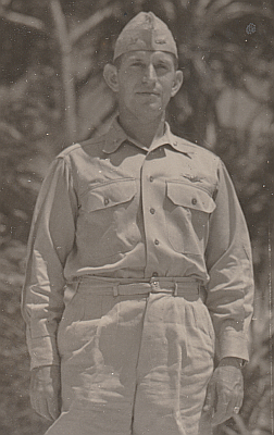 Captain R.N. Hunter wears the Army type convertible collar khaki shirt with garrison cap and shorts in the South Pacific in 1944. The aviation badge is worn on the left breast and rank on the collar.  On the left side of the garrison cap is a miniature aviation badge and on the right is rank insignia. 