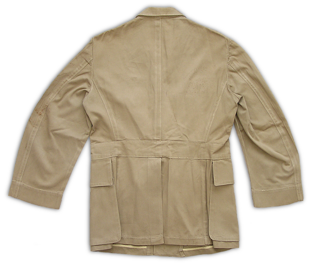 Back view of the commissioned officer's khaki cotton working coat.  The rear of the coat had a vent extending from the beltline to the hem, which allowed easier movement, especially when bending. 