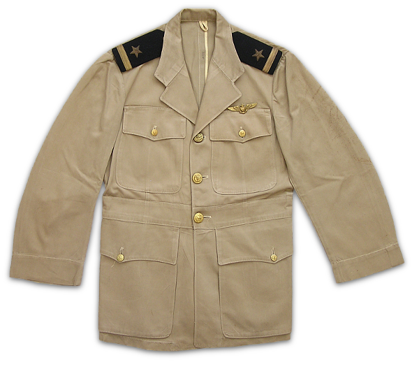 Front view of the commissioned officer's khaki working coat with ensign shoulder marks and aviator badge over the left breast pocket.  The coat was notable for its large, bellows lower pockets and the sewn on belt that extended around the midsection. 