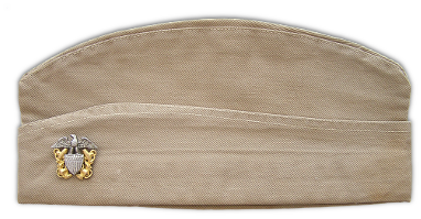 Left side of khaki cotton garrison cap with miniature commissioned officer's cap device. Pilots wore miniature wings on the left side of the cap into 1943 when all officers were then ordered to wear the miniature cap device. 