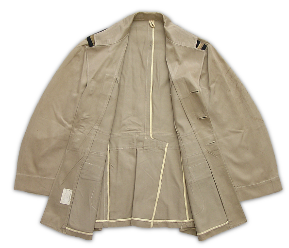 Inside view of the unlined khaki cotton working coat.  Though Navy regulations allowed for inside pockets, wartime examples were kept economical and seldom had them.