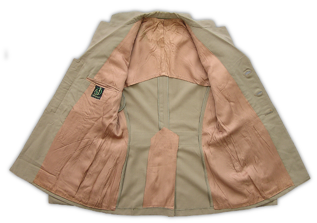Inside view of the tropical wool khaki coat showing the rayon lining.  These coats required a lining because the light wool fabric showed sweat easily.  Linings could be partial or full with some just covering the upper back, shoulders, and underarms, while others covered the entire inside of the coat.