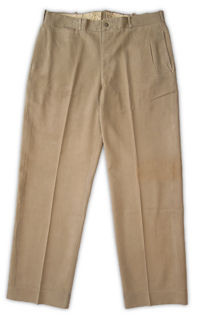 Front view of US Navy khaki cotton working trousers. These trousers were a simple design with two front and two rear pockets, a watch pocket, and a button fly. Navy regulations stated that when worn together, the coat, trousers, and cap, should all be made of matching material.