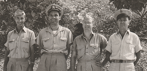 This photo taken in 1944 in the Pacific shows Navy officers wearing an assortment of different khaki shirt designs along with khaki tropical shorts.  Note the different collars, button plackets, and pocket designs.  A variety such as this was a common sight during the WW2 years.    The man second from left wears the tropical short-sleeve shirt that was designed to go with the shorts and the man third from left wears a khaki USMC shirt. 